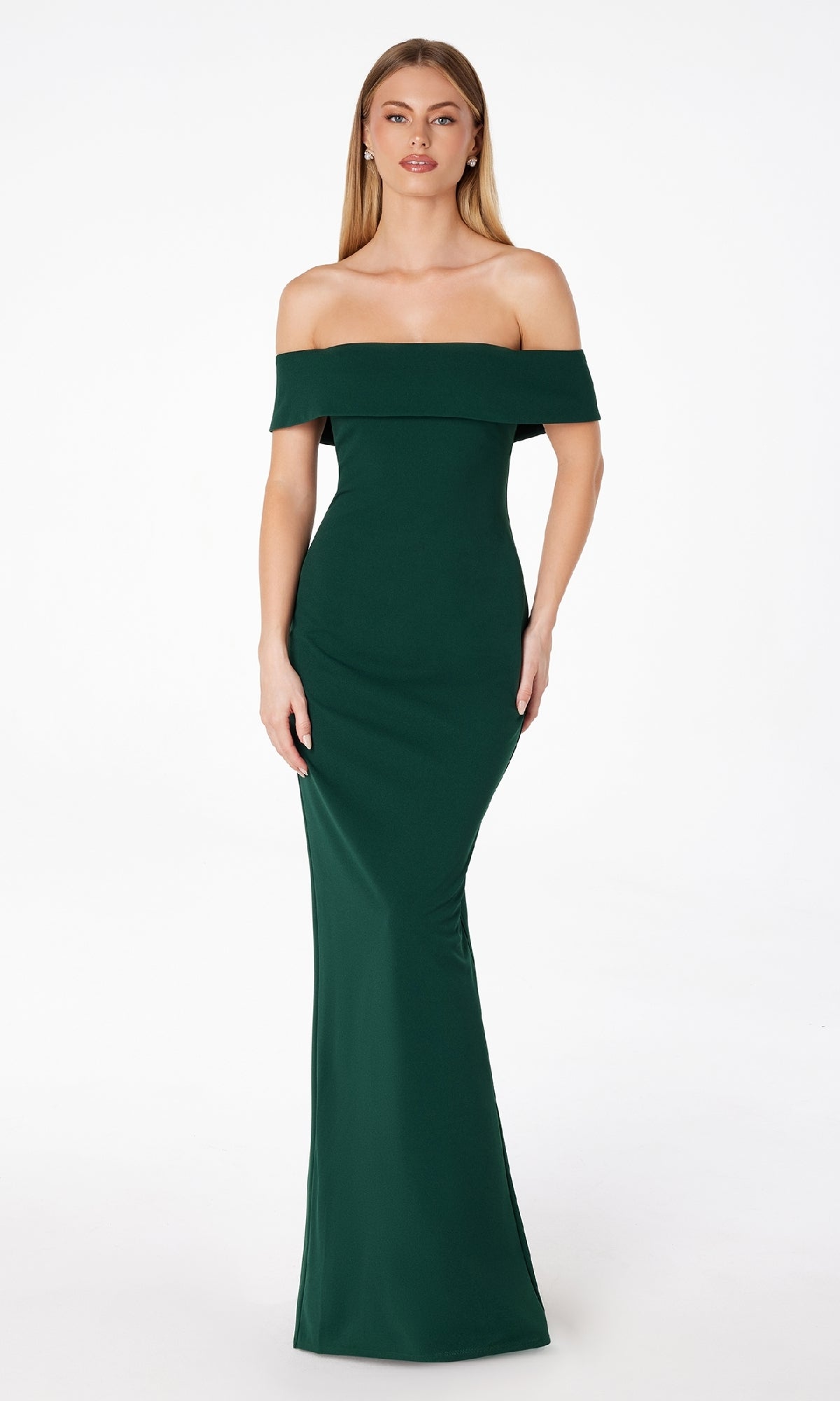 A woman wears the Astee T2011, an off-the-shoulder long prom dress in dark green, styled as a classic formal evening gown, standing against a plain white background.